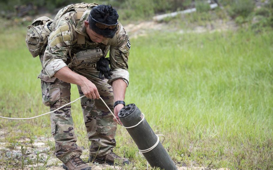 An explosive ordnance disposal airman removes a rocket after a simulated attack during the operational phase of the beta test of the EOD Tier 2 fitness test prototype, Sept. 10, 2018, at Eglin Air Force Base, Fla.