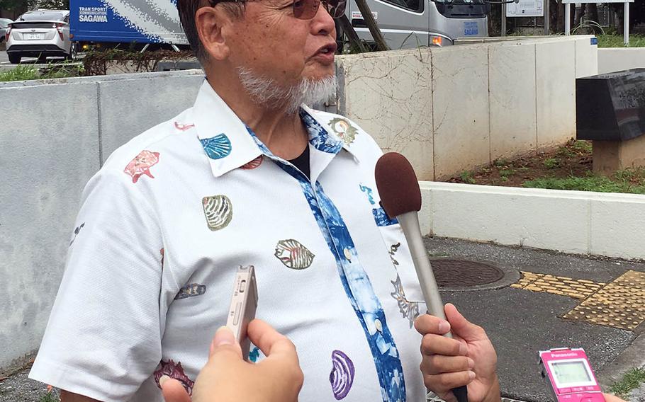 Kenei Yamashiro, a leader of a group seeking $10 million in damages over noise from Marine Corps Air Station Futenma, speaks to reporters near Naha District Court, Friday, Sept. 28, 2018.