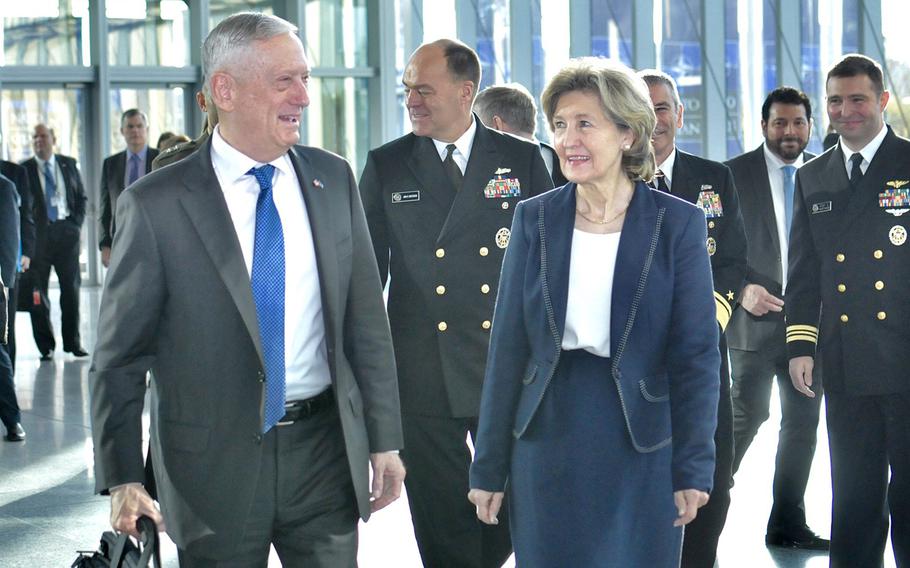 Defense Secretary Jim Mattis is met at  NATO Headquarters in Brussels, Belgium by Kay Bailey Hutchison, the American ambassador to NATO on his way to the the NATO defense ministers' meeting, Wednesday, Oct. 3, 2018.