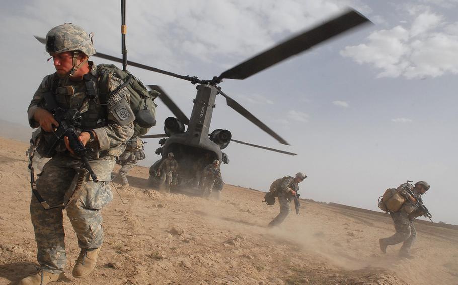 Soldiers hustle from the belly of a Chinook helicopter during a July 18, 2007, air assault in Afghanistan. Nearly half of Americans think the U.S. has failed to achieve its goals in what has become the longest war in the nation's history, according to a new Pew Research Center poll.