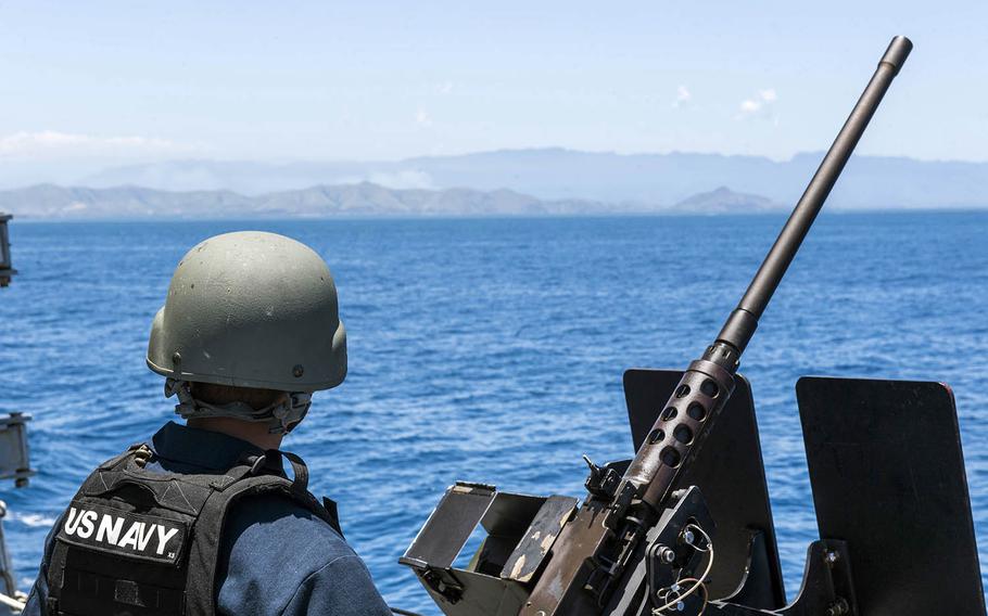 Petty Officer 2nd Class Christian Koch stands watch aboard the guided-missile destroyer USS Michael Murphy as it arrives in Papua New Guinea, Saturday, Oct. 6, 2018.