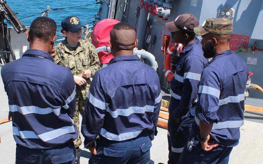 Ensign Cynthia Castagnaro speaks with members of the Papua New Guinea Defense Force aboard the USS Michael Murphy at Port Moresby, Papua New Guinea, Sunday, Oct. 7, 2018.