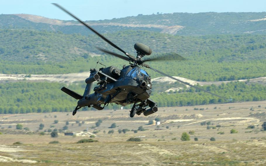 A U.S. Army AH-64 Apache helicopter flies over the San Gregorio training area near Zaragoza, Spain, during NATO's Trident Juncture 15 exercise in November 2015.