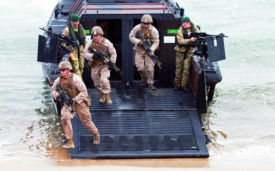 U.S. Marines disembark from a British marine amphibious assault vehicle during a beach landing exercise as part of Trident Juncture 15 in Troia, Portugal, in November 2015.