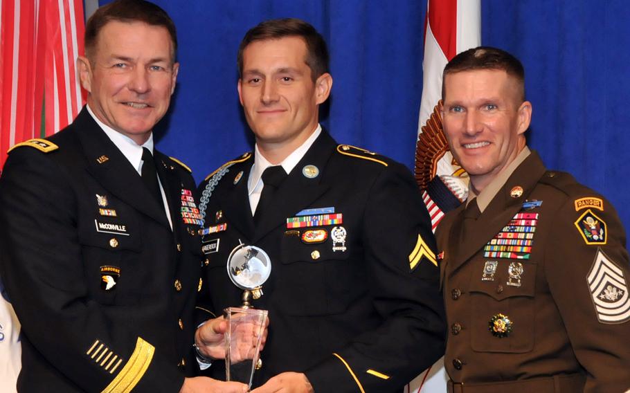 Cpl. Matthew Hagensick, center, the 2018 Soldier of the Year, poses with Army Vice Chief of Staff James McConville, left, and Sergeant Major of the Army Dan Dailey, right, on Oct. 8, 2018, at the Association of the United States Army annual meeting in Washington, D.C.