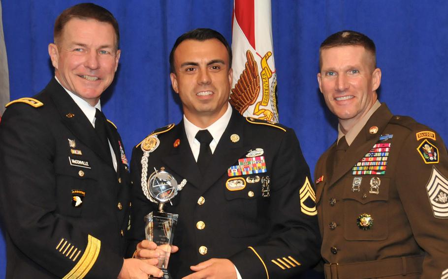Sgt. 1st Class Sean Acosta, center, the U.S. Army's 2018 NCO of the Year poses with Army Vice Chief of Staff James McConville, left, and Sergeant Major of the Army Dan Dailey, right, on Oct. 8, 2018, at the Association of the United States Army annual meeting in Washington, D.C.
