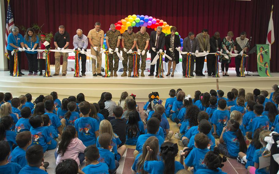 Leaders, faculty, students and architects of the new Zukeran Elementary cut the ribbon for the new school at Camp Foster, Okinawa, Wednesday, Oct. 10, 2018.