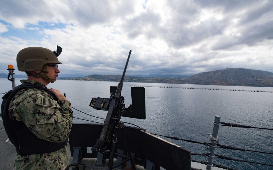 Petty Officer 1st Class Adam Foti stands watch aboard the destroyer USS Winston S. Churchill as the ship departs Souda Bay, Greece, Oct. 9, 2018.
