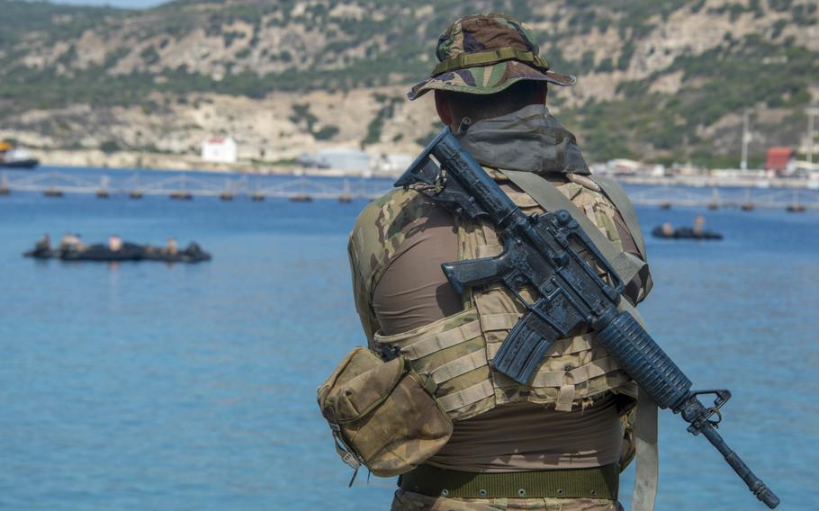 A Greek navy special forces sniper watches maritime operations during training with U.S. forces in Souda Bay, Greece, on Sept. 11, 2018.