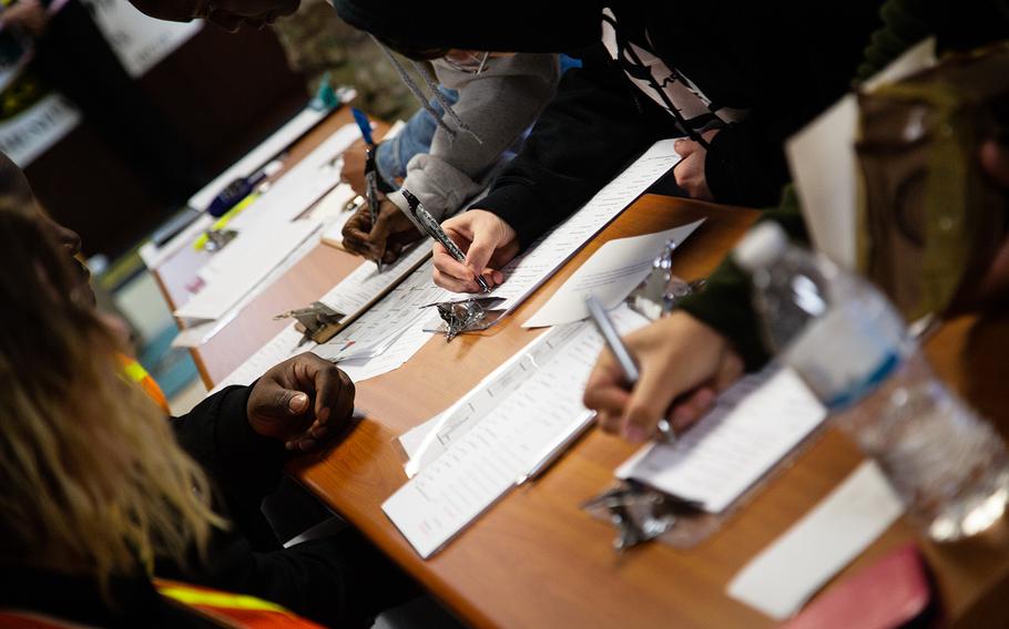 Soldiers fill out foms after being evacuated during an exercise at Yongsan Garrison in Seoul, South Korea, Thursday, Oct. 11, 2018.