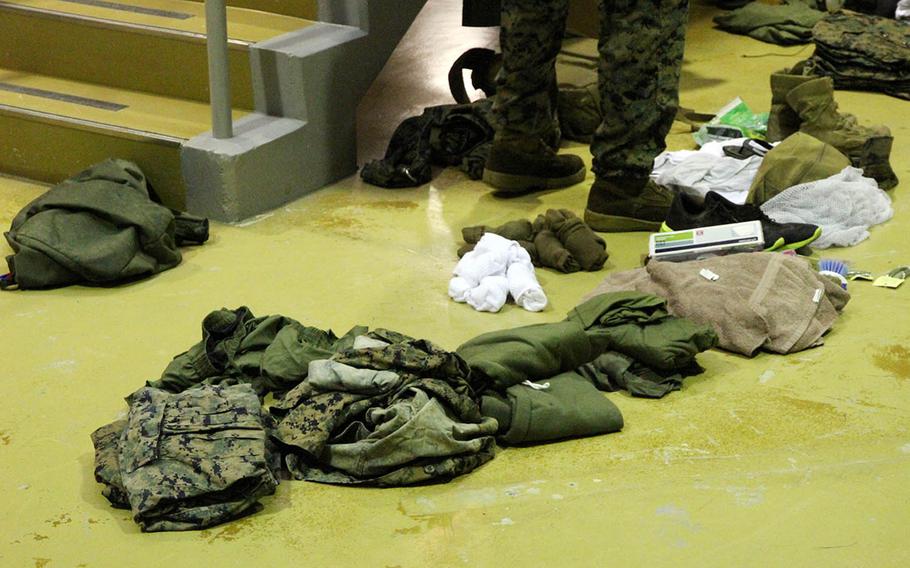 Marines empty the contents of their sea bags at the Camp Hansen brig as they arrive for the Correctional Custody Unit 2.0 program in August.