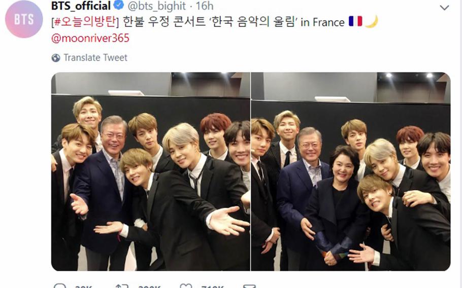 Members of the boy band BTS pose with South Korean President Moon Jae-in and his wife, Kim Jung-sook, in photos posted to the group's official Twitter account.