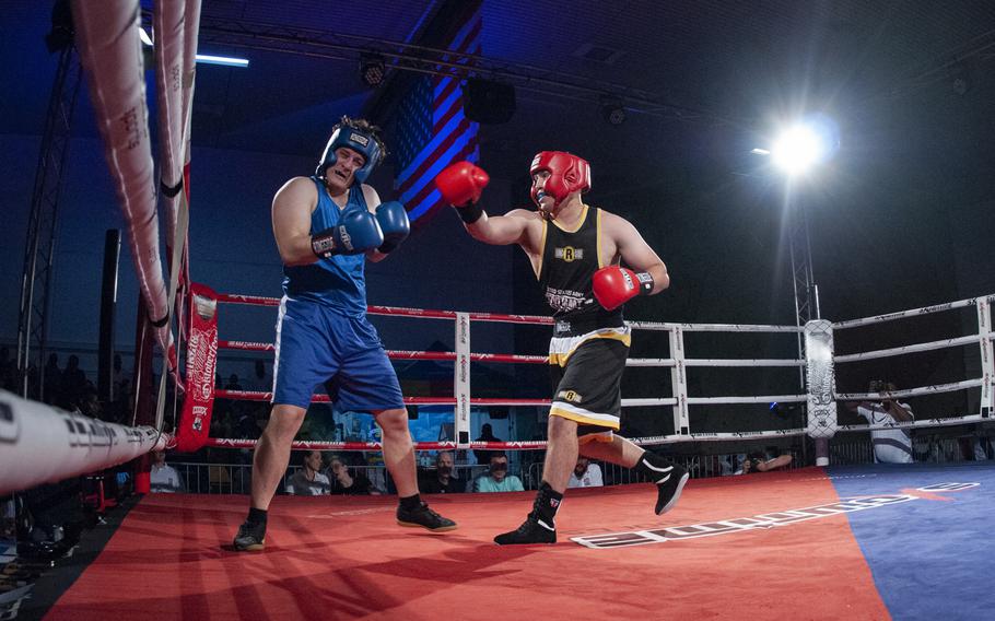 Sloan Grey, right, of Stuttgart follows through after landing a right hook against Brenden Chernis of Baumholder during their super heavyweight bout at the Oktoberfest Boxing Championships in Stuttgart.  Grey won the Saturday night fight. 
