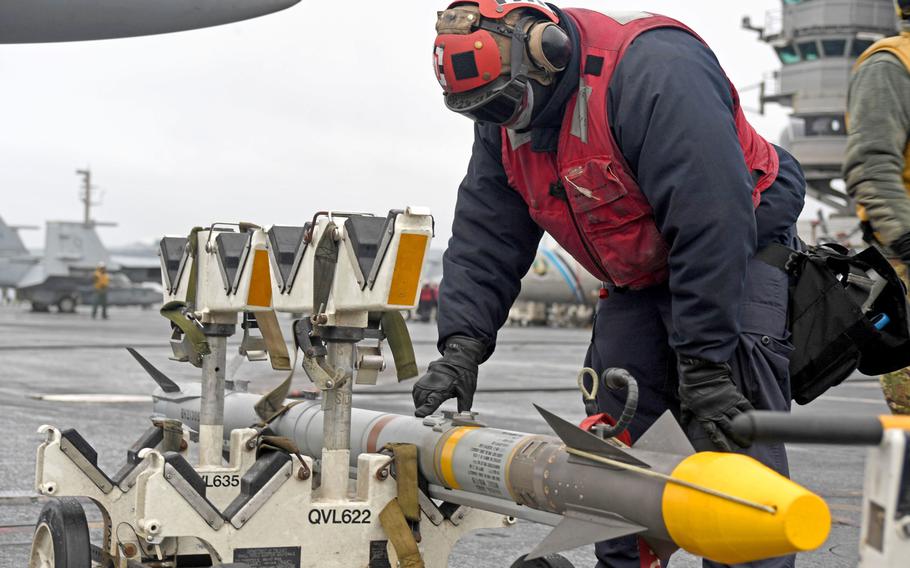 Seaman Kesean Mikell, an airman assigned to Strike Fighter Squadron 11, performs an ordnance check on the flight deck aboard the aircraft carrier USS Harry S. Truman, Oct. 19, 2018. This is the first time in nearly 30 years a U.S. aircraft carrier has entered the Arctic Circle.