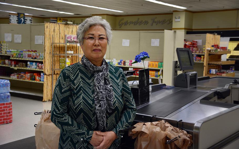 Lee Jong-Sook, 69, who has worked as a bagger at the Camp Red Cloud commissary since 2001, poses at her station, Sunday, Oct. 21, 2018.