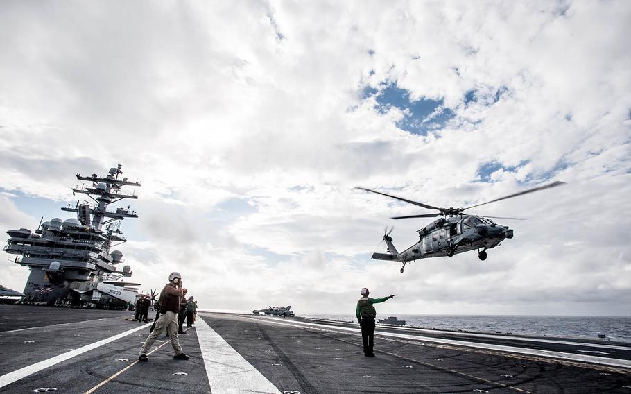 An MH-60S Seahawk takes off from the flight deck of the aircraft carrier USS Ronald Reagan in waters south of Japan in 2015.