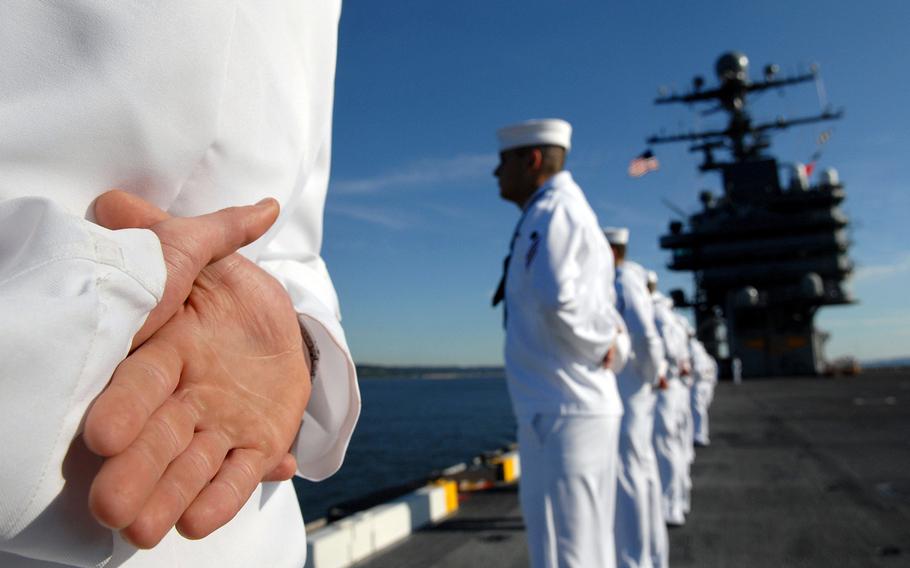 Sailors man the rails aboard the aircraft carrier USS Abraham Lincoln at Naval Station Everett, Wash., in 2007.