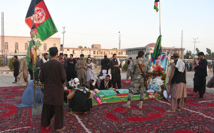 Mourners visit the grave of former Kandahar police chief Gen. Abdul Raziq on Thursday, Oct. 25, 2018, one week after Raziq was assassinated in an attack claimed by the Taliban.
