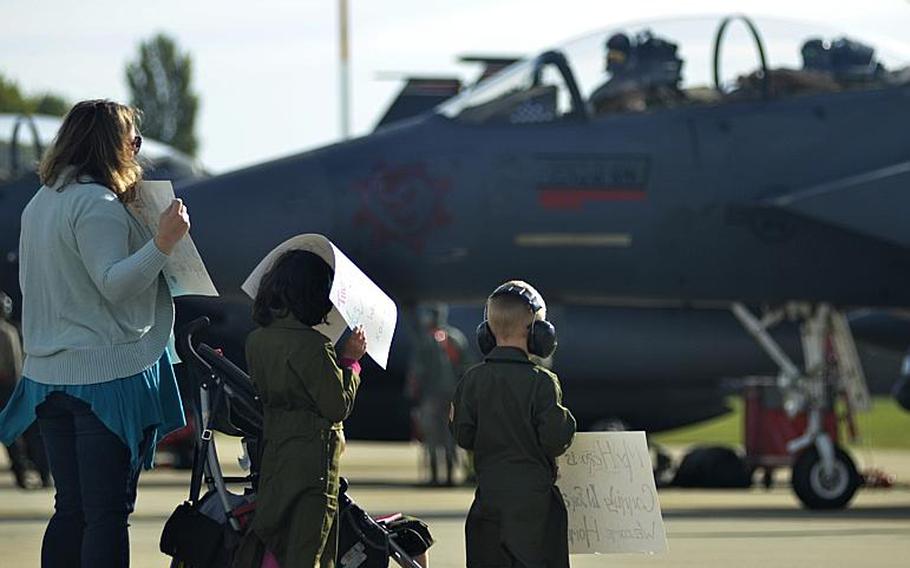 Family members patiently await an F-15E Strike Eagle pilot  returning home from a six-month combat deployment against the Islamic State to RAF Lakenheath, England, Sunday, Oct. 7, 2018. The 494th Fighter Squadron flew 2,000 sorties in about 11,000 flight hours and dropped more than 500 precision-guided munitions in support of U.S. Central Command operations.