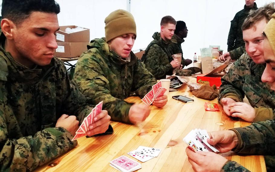 Marines playing cards with their warming layers on during chow at Exercise Trident Juncture, near Rennebu, Norway, Wednesday, Oct. 31, 2018.
