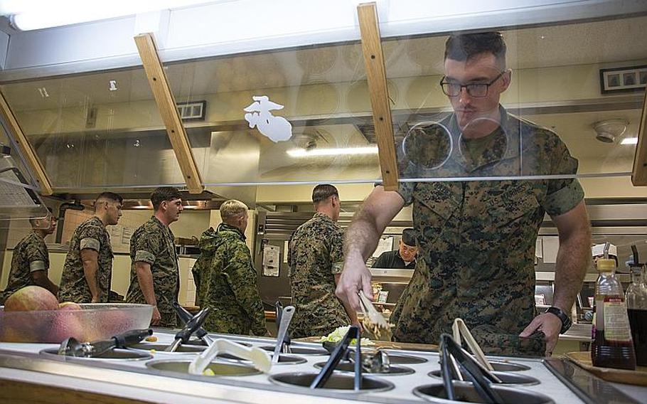 A Marine grabs a meal at the 12th Marines Mess Hall at Camp Hansen, Okinawa, Oct. 12, 2018.