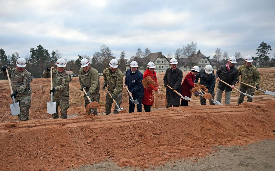 Army and community leaders shovel dirt at the groundbreaking for the new elementary school at Grafenwoehr, Germany, Tuesday, Nov. 20, 2018.