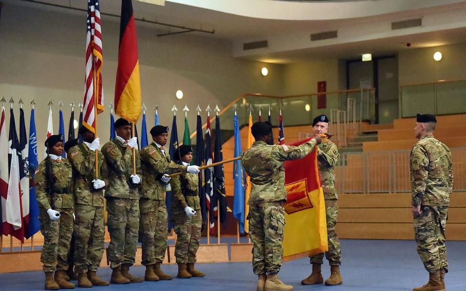 Sgt. Maj. Samuel Zoker, left, and Col. Seth Knazovich, the sergeant major and commander of the 41st Field Artillery Brigade, respectively, uncase the unit's colors at the activation ceremony, at Grafenwoehr, Germany, Friday, Nov. 30, 2018.