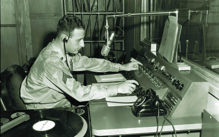 A soldier cues up a record for the Far East Network in Japan in 1952, the second year of the Korean War.