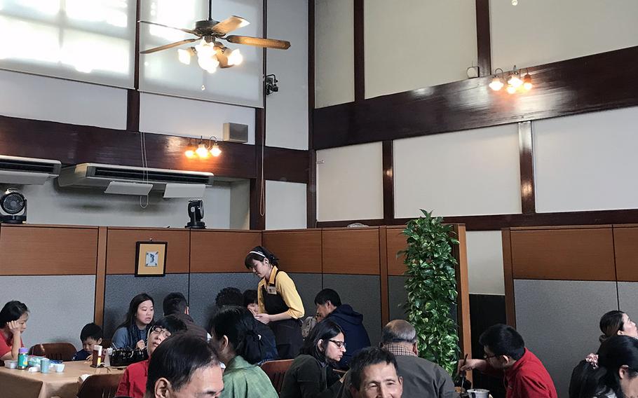 Customers enjoy tonkatsu in Maisen's large dining room. The restaurant is located in what used to be an old Japanese bathouse, and many of the original features remain.