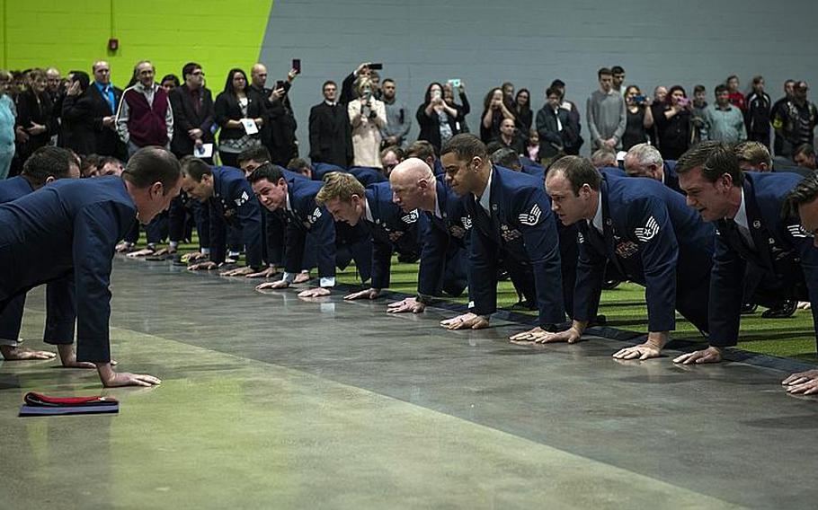 Airmen and family members perform memorial pushups in honor of Air Force Staff Sgt. Dylan Elchin, a combat controller with the 26th Special Tactics Squadron, during a memorial service in Moon Township, Pa., on Thursday, Dec. 6, 2018. 