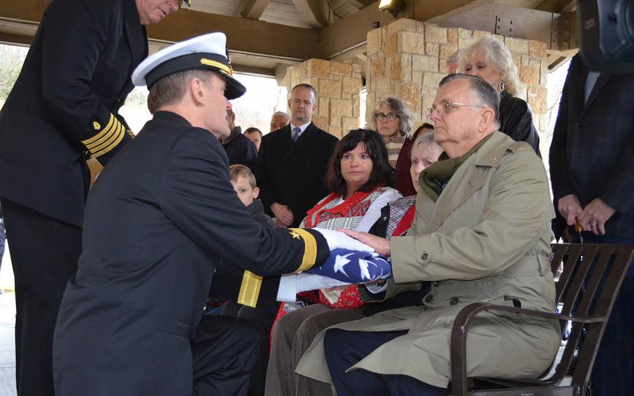 Charles Kane receives a flag in honor of the sacrifice of his uncle Fireman 1st Class Albert Kane, who died during the attack on Pearl Harbor. He was buried Friday at the Dallas Fort Worth National Cemetery.