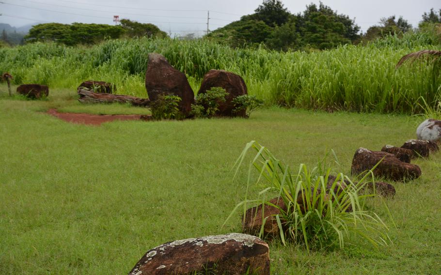 A path at Kukaniloko Birthstones State Monument leads to one of the larger boulders, where local Hawaiians often leave flowers and other offerings.
