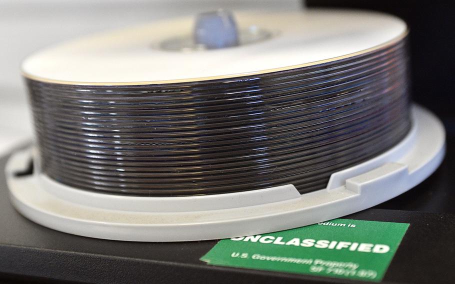 Without a web-based way to send large files containing personal or medical information, the military now has to burn the data onto optical discs, like the DVDs pictured here in an Army facility on Dec. 10, 2018, and send them via registered mail.