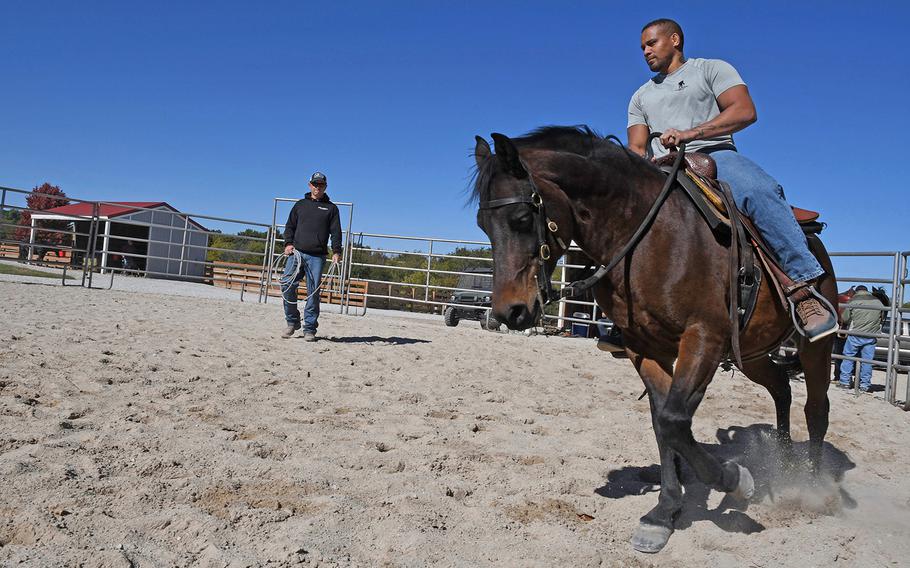 War Horses for Veterans co-founder and director Patrick Benson teaches some basic riding skills to a combat veteran during one of a weekend retreat at the nonprofit's ranch in Stillwell, Kansas.