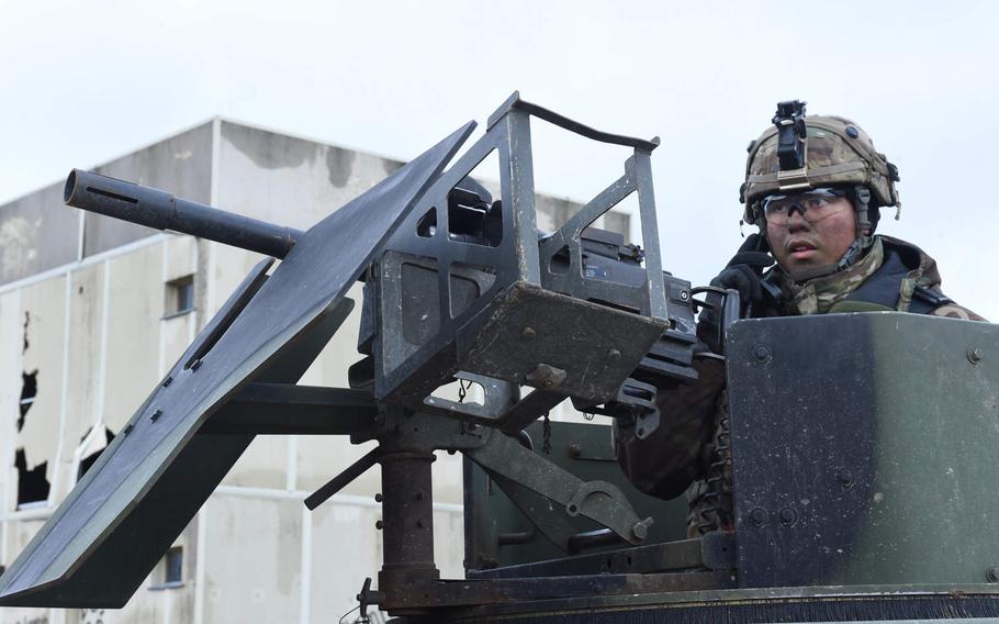 Sgt. Luke Caney, a gunner with the 615th Military Police Company, talks on the radio from atop his Humvee at  Combined Resolve XI, at Hohenfels, Germany, Monday, Dec. 10, 2018.