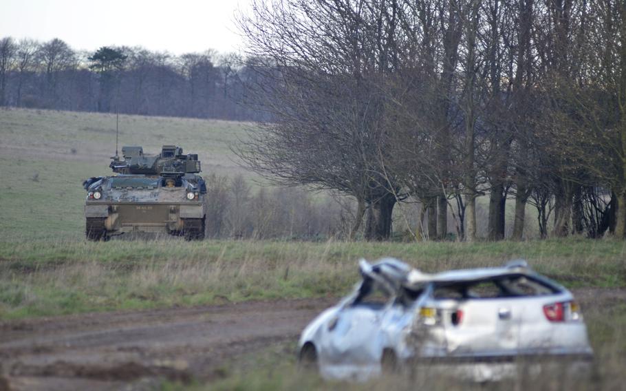 A British Warrior infantry fighting vehicle is remotely controlled into position during a demonstration for Exercise Autonomous Warrior on the Salisbury Plain Training Area, England, Monday, Dec. 10, 2018. A human driver was present in the vehicle for safety reasons.