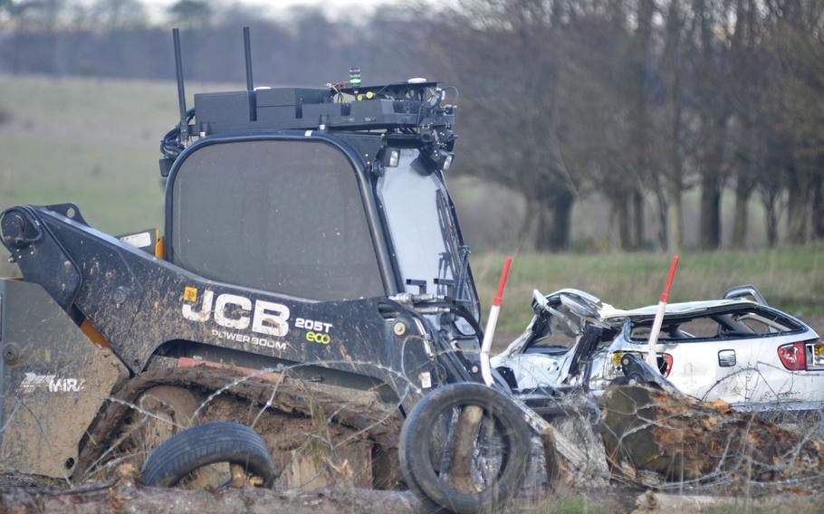 An unmanned Horiba Mira Bobcat clears away debris during a demonstration for Exercise Autonomous Warrior on the Salisbury Plain Training Area, England, Monday, Dec. 10, 2018. The fourth annual Army Warfighting Experiment is a collaborative effort focused on using unmanned aerial and ground vehicles.