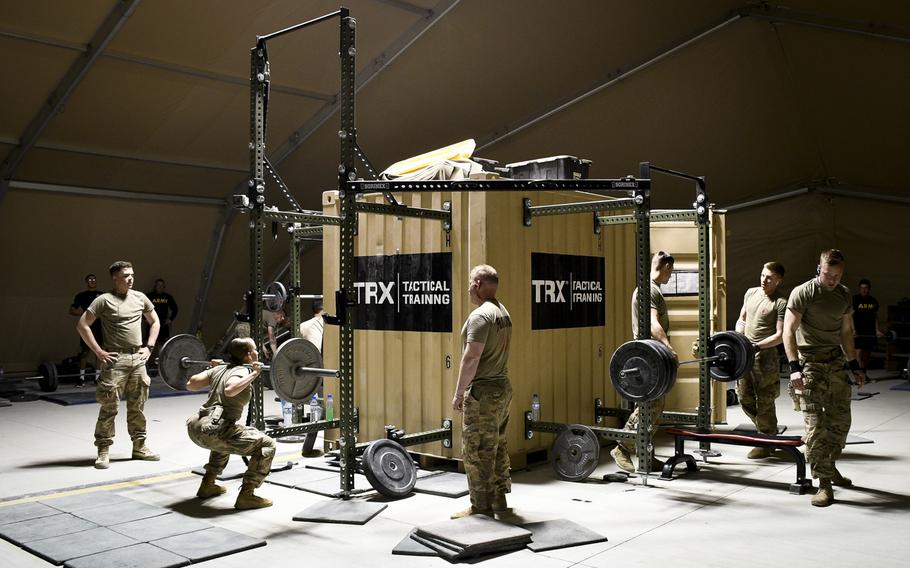 Soldiers at Camp Dahlke West in Afghanistan lift weights Dec. 16, 2018 in a gym on base. The once sparse base had no gym as of April last year, and soldiers resorted to building gym equipment out of spare lumber. The new gym is part of a rapid expansion of the base to host the 1st Security Force Assistance Brigade in 2018 and the 2nd SFAB in 2019.