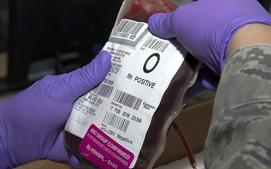 A servicemember inspects a red blood cell unit before placing it in a box to be shipped. On Dec. 17, 2018, Landstuhl Regional Medical Center in Germany said an employee is under investigation for potentially threatening the hospital's blood supply.