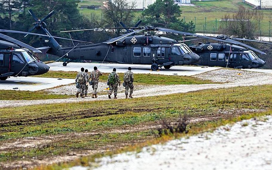Soldiers assigned to the 4th Aviation Regiment, 4th Combat Aviation Brigade, 4th Infantry Division walk toward UH-60 Black Hawk helicopters during exercise Combined Resolve XI in Hohenfels Training Area, Germany, Dec. 5, 2018. The Army has negotiated refunds for about 250 soldiers from the unit who bought airline tickets before their vacations were approved by a higher command.
