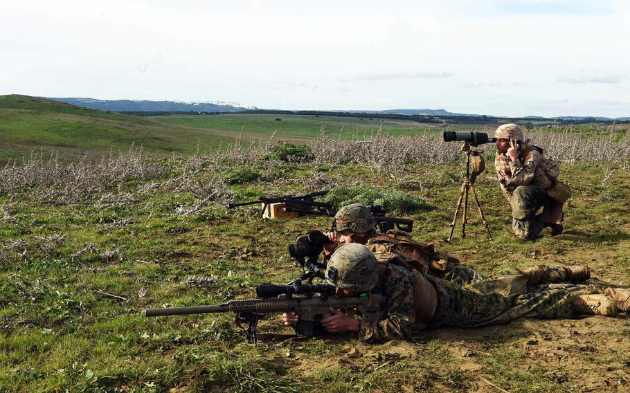 U.S. Marine Corps scout snipers with the Special Purpose Marine Air-Ground Task Force Crises Response Africa, take aim as a Spanish reconnaissance soldier spots their shots, during sniper training near Vejer de la Frontera, Spain, Wednesday, Dec. 19, 2018.