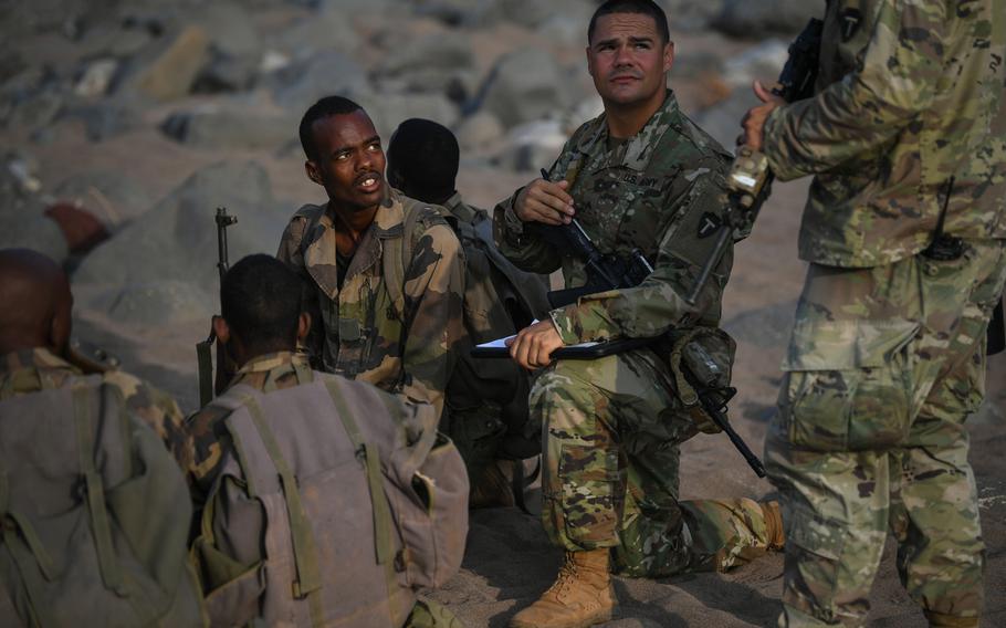 U.S. Army Sgt. Patrick Wilhoite with the 1st Battalion, 141st Infantry Regiment, Bravo Company, Texas Army National Guard, gives instruction on infantry tactics and procedures to Djiboutian soldiers with the Rapid Intervention Battalion outside Djibouti City, Djibouti, Dec. 18, 2018.