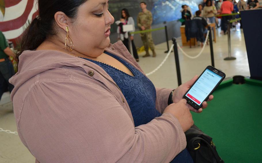 Lilia Van Dyke, a runner for the delivery app JoyRun, demonstrates how she uses the app on her smartphone at Operation Phantom Support in Killeen, Texas, on Dec. 13, 2018.