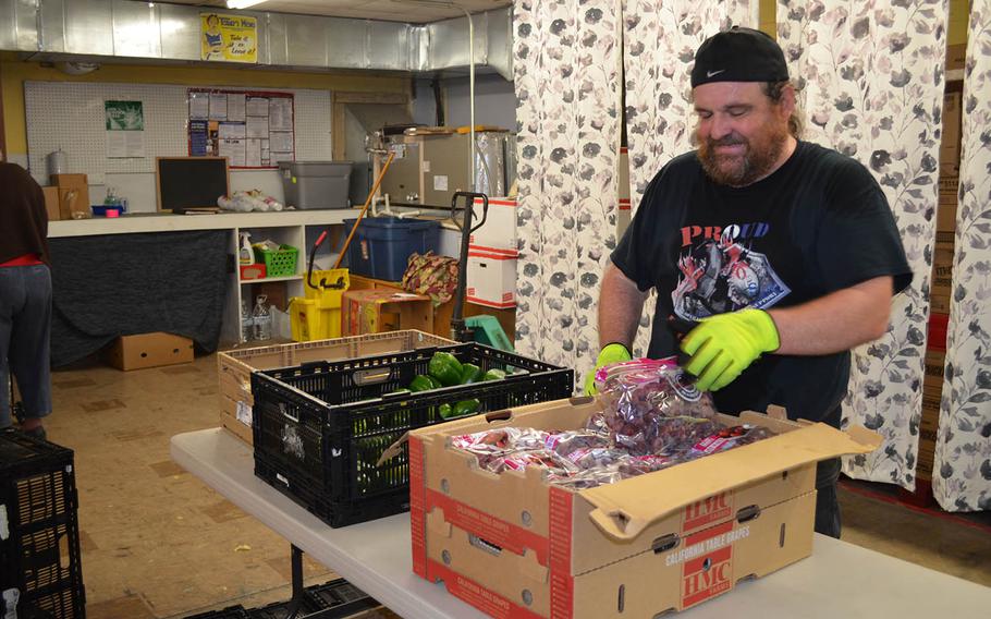 Patrick Bilodeau sorts grapes to hand out as a volunteer at Operation Phantom Support???s food pantry in Killeen, Texas on Dec. 13.