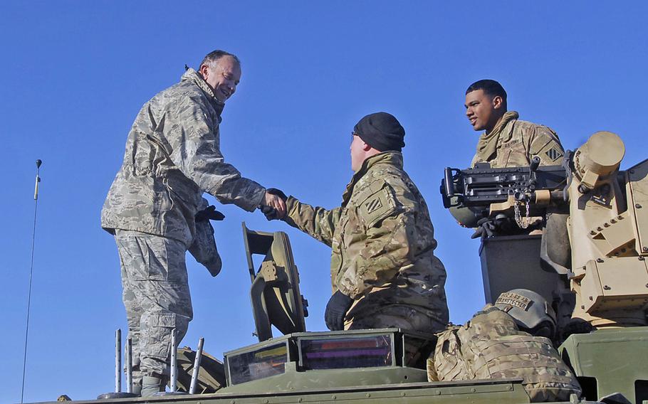 U.S. European Command's Gen. Philip Breedlove stands atop an Abrams tank to meet with U.S. soldiers taking part in training at the Zagan Training Area in Poland on Tuesday, Nov. 24, 2015. A task force led by Breedlove, now retired from the military, is recommending a beefed up American military force in Poland, home-porting Navy destroyers in Denmark and other steps to muscle up against a Russian military that has allies outgunned in the east.