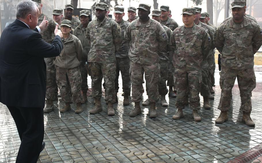 Deputy Secretary of State John J. Sullivan gives the thumbs-up to U.S. troops at NATO's Resolute Support headquarters in Kabul, Afghanistan, in January. President Donald Trump has directed the Pentagon to come up with a plan to withdraw nearly half of the more than 14,000 troops deployed to Afghanistan.
