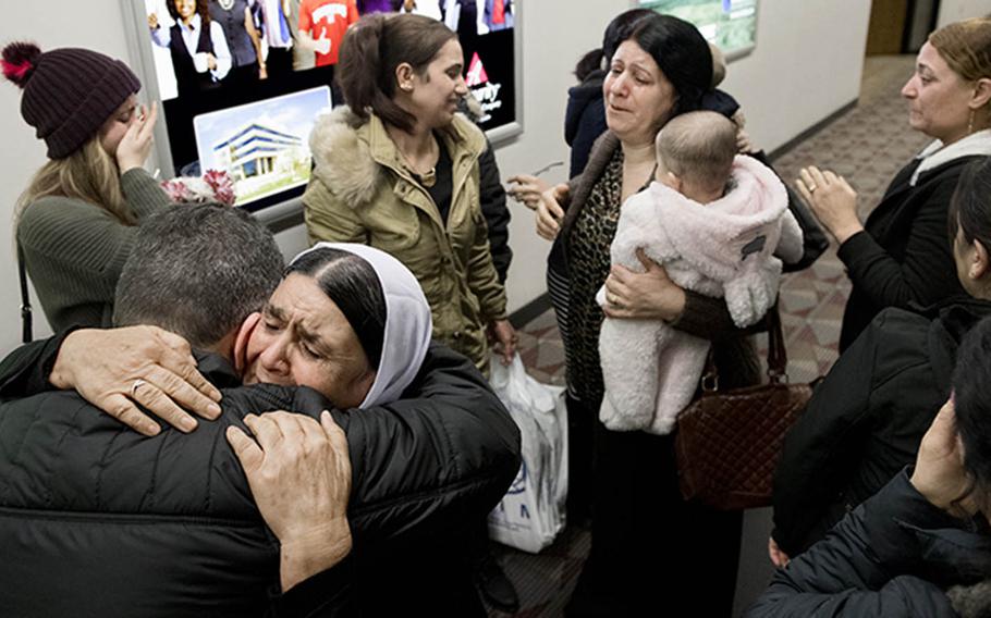It's an emotional reunion as the family of Barakat Al Bashar, a Yazidi interpreter killed by a suicide bomber in Iraq in 2007, arrives in Lincoln, Neb., Dec. 19, 2018. They were met by Hadi Pir, a Lincoln Yazidi who was an interpreter alongside Barakat, and are moving into his house until they can get their own place.