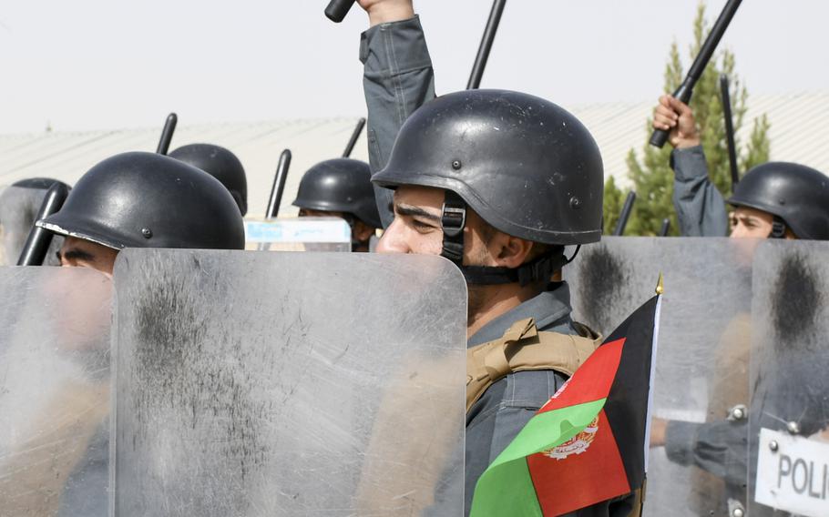 Afghan police in training raise their batons in the air before banging them on their riot shields during a crowd-control drill at the Regional Police Training Center in Herat, Oct. 28, 2018. Responsibility for training police primarily belongs to Afghan mentors, with allied troops now focusing on advising at higher echelons and with Afghan special operations. 