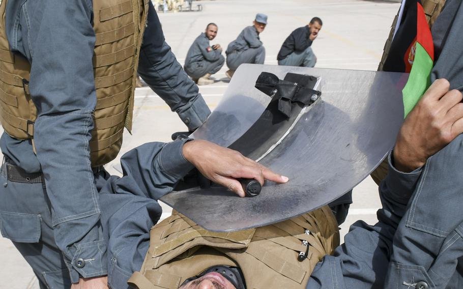 Afghan police in training carry a simulated injured officer away during a crowd-control drill at the Regional Police Training Center in Herat, Oct. 28, 2018. Responsibility for training police primarily belongs to Afghan mentors, with allied troops now focusing on advising at higher echelons and with Afghan special operations. 
 
J.P. Lawrence/Stars and Stripes