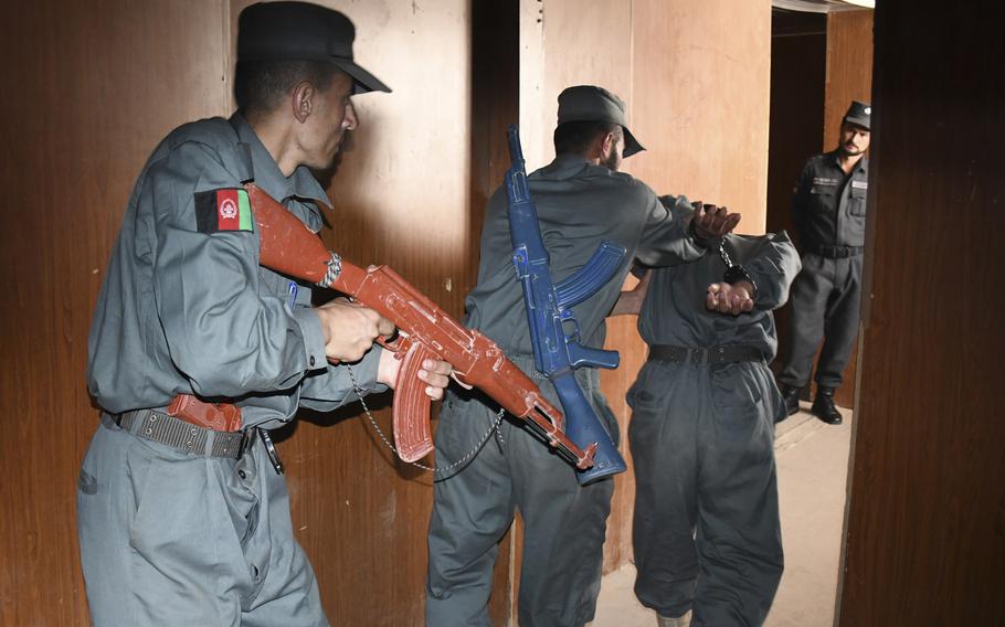 Afghan police in training practice detaining and arresting each other as an instructor looks on at the Regional Police Training Center in Herat, Oct. 28, 2018. Responsibility for training police primarily belongs to Afghan mentors, with allied troops now focusing on advising at higher echelons and with Afghan special operations. 
 
